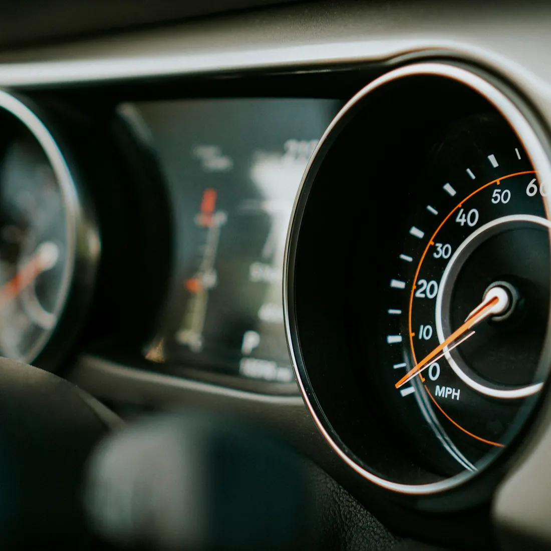 A car instrument cluster in close-up, its speedometer marked in miles per hour.